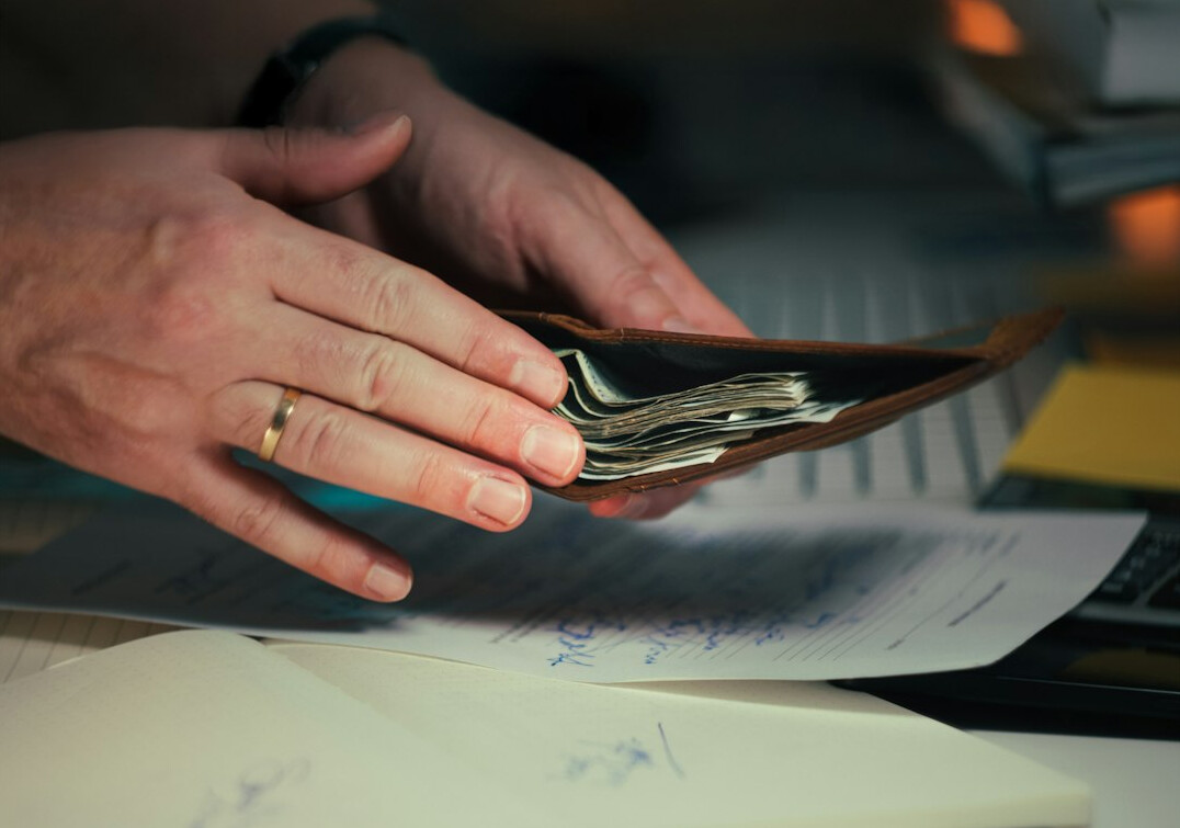person calculating debt payments